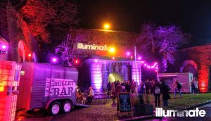 Night shot of uplit outdoor concessions at Illuminate