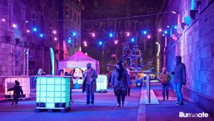 Street view of pedestrians walking around Illuminate