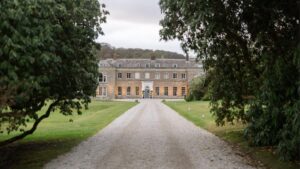 A destination wedding venue featuring an elegant building and a sweeping grand driveway.