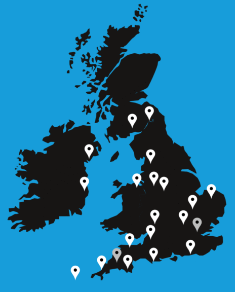 A grey map of the UK with a blue background featuring pin points where JHAV have worked nationally.